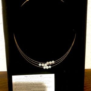 Triple strand gold and floating pearl necklace.